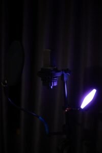 A studio microphone with purple lighting