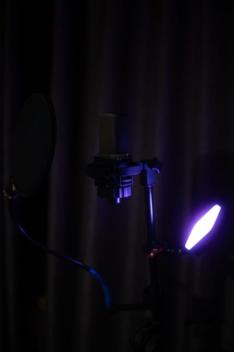 A studio microphone with purple lighting
